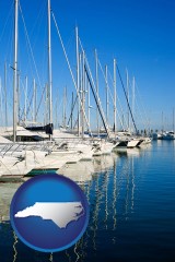 north-carolina map icon and sailboats in a marina